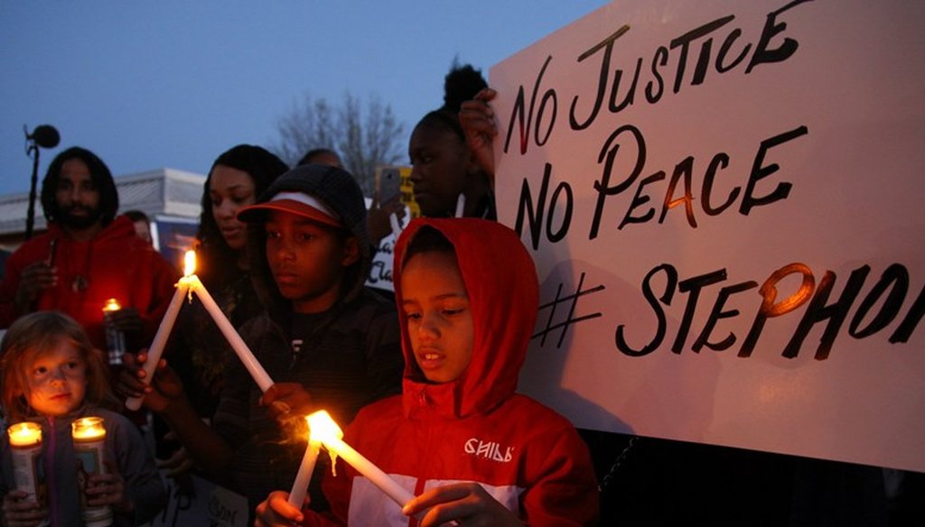 Children light candles at a vigil for Stephon Clark in South Sacramento. Andrew Nixon / Capital Public Radio