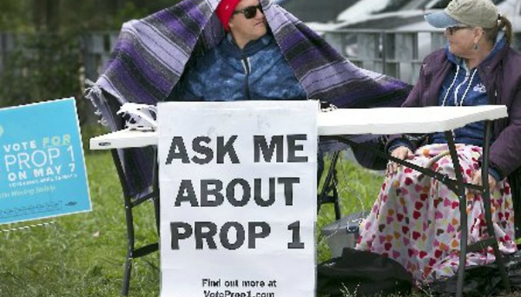 On a chilly day, proponents of Proposition 1 on Austin's May 7, 2016, ballot await voters (Austin American-Statesman, Ralph Barrera).