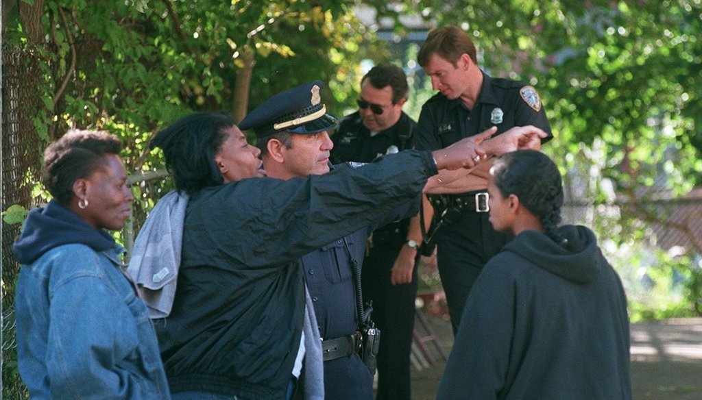 Sgt. Ralph Abernathy of Providence Police speaks with witnesses and neighbors at the scene of a shooting on Public Street in Providence in 1998. (The Providence Journal / Mary Murphy)