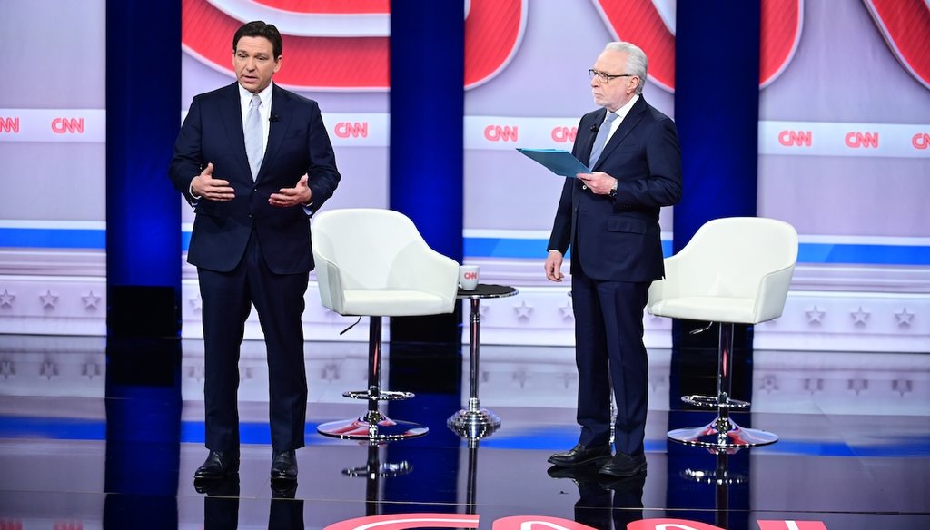 Florida Gov. Ron DeSantis, left, and CNN anchor Wolf Blitzer, right, stand onstageJan. 16, 2023,  for a CNN town hall at New England College in Henniker, New Hampshire. (Photo courtesy CNN)