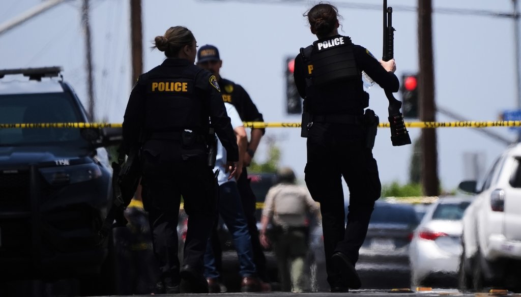 People carry weapons at the scene of a shooting outside the Islamic Center of San Diego, May 18, 2026, in San Diego. (AP)