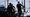 People carry weapons at the scene of a shooting outside the Islamic Center of San Diego, May 18, 2026, in San Diego. (AP)