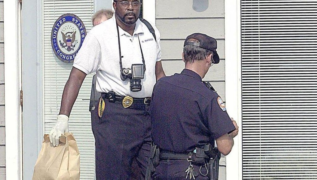 Fort Walton Beach Police Department evidence technician Dusty Rhodes leaves the Fort Walton Beach, Fla., office of Rep. Joe Scarborough, R-Fla., on July 20, 2001, after an aide was found dead. (AP/Northwest Florida Daily News)