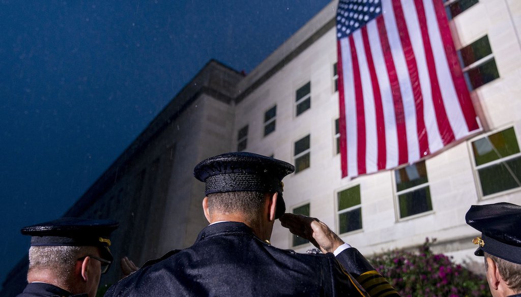 First responders salute as a U.S. flag is unfurled at the Pentagon in Washington, Sept. 11, 2022 (AP)