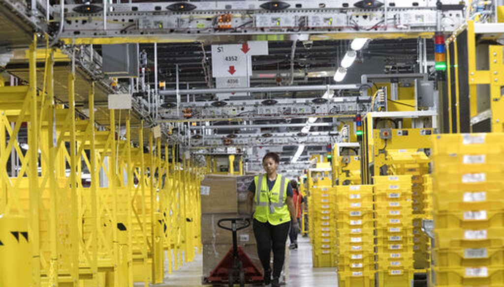 An Amazon employee moves merchandise through a fulfillment center in New York on Dec. 5, 2018. (AP/Altaffer)