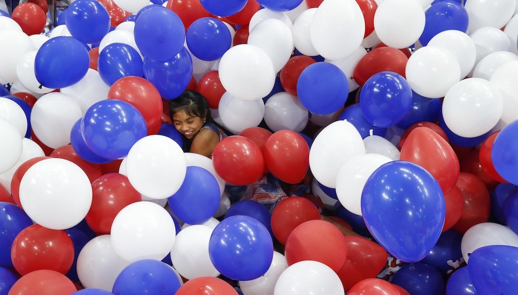 Karla Ortiz, 11, of Las Vegas, dives into balloons on the floor after the Democratic National Convention in Philadelphia on July 29, 2016. (AP)