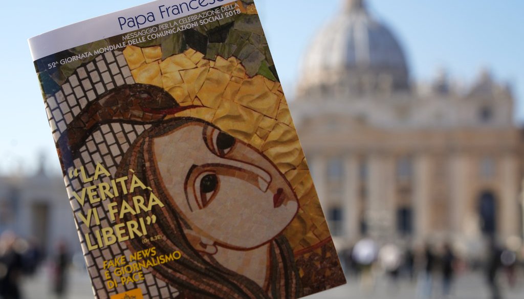 Pope Francis' book on "fake news" is pictured in front of St. Peter's Basilica in Rome on Jan. 24, 2018. The pope released his annual social communication dedicated that year to "fake news and journalism for peace." (AP)