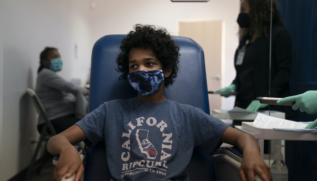 Marcus Morgan, 14, waits to receive his Pfizer COVID-19 vaccination through Families Together of Orange County in Tustin, Calif., Thursday, May 13, 2021. The state began vaccinating children ages 12 to 15 this spring. (AP Photo/Jae C. Hong)