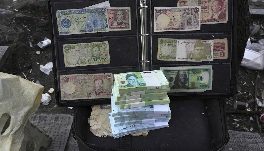 Current and pre-revolution Iranian banknotes and foreign currencies are displayed by a vendor in downtown Tehran, Iran, on Feb. 26, 2023. (AP)