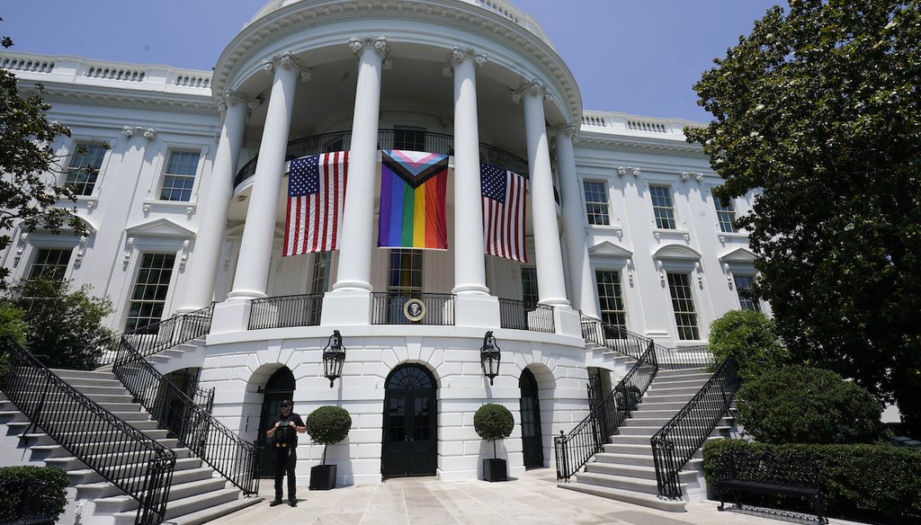 American flags and a pride flag hang from the White House during a Pride Month celebration on the South Lawn, June 10, 2023, in Washington. (AP)