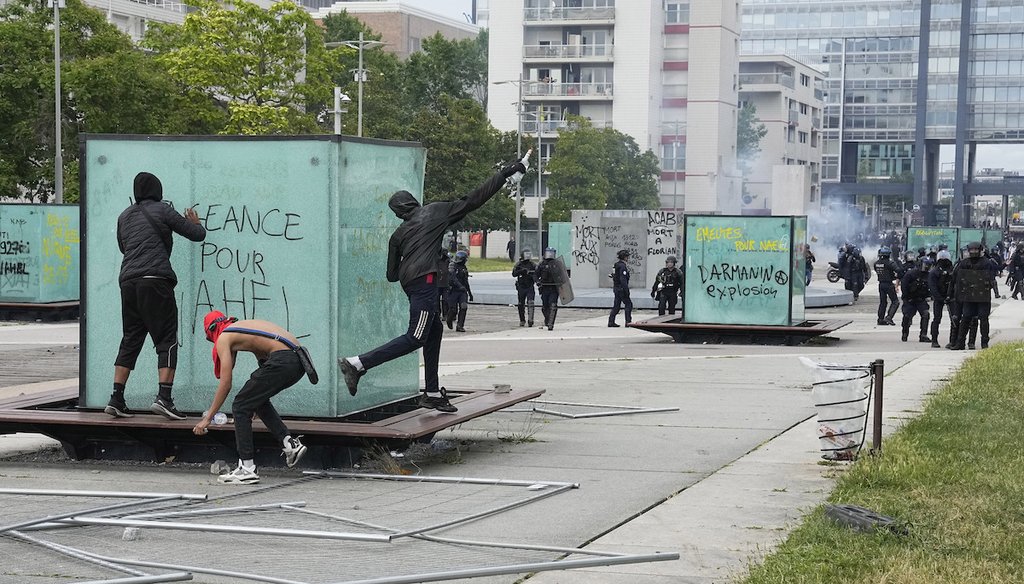 A protester throws a bottle to police forces during riots on June 29, 2023, in Nanterre, outside Paris. (AP)