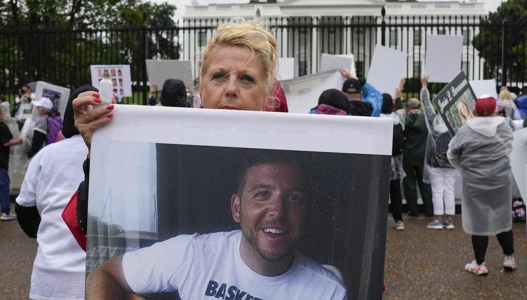 Diane Marsh holds a bottle containing the ashes of her son Peyton Marsh as she joins others protesting in front of the White House to raise awareness of opioid-related deaths on Sept. 23, 2023, in Washington. (AP)