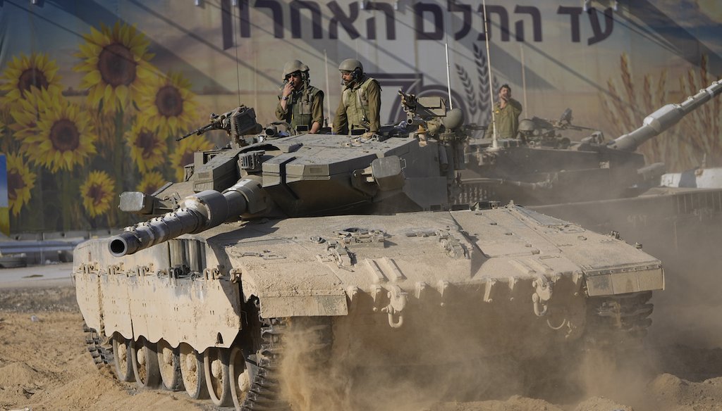 Israeli soldiers move a tank at a staging area near the border with Gaza on Oct. 15, 2023. (AP)