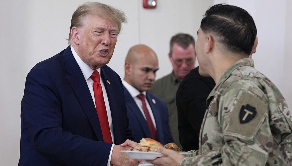 Republican presidential candidate and former President Donald Trump, left, helps serve food to Texas National Guard soldiers, troopers and others who will be stationed at the border over Thanksgiving, Nov. 19, 2023, in Edinburg, Texas. (AP)