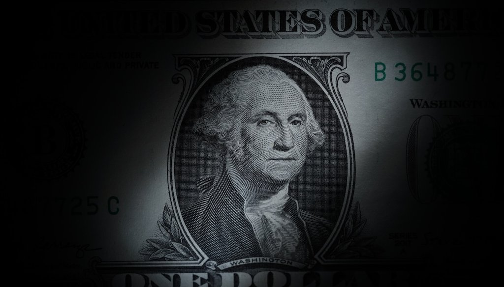 George Washington peers out from a U.S. one dollar bill in March 2023. (AP)