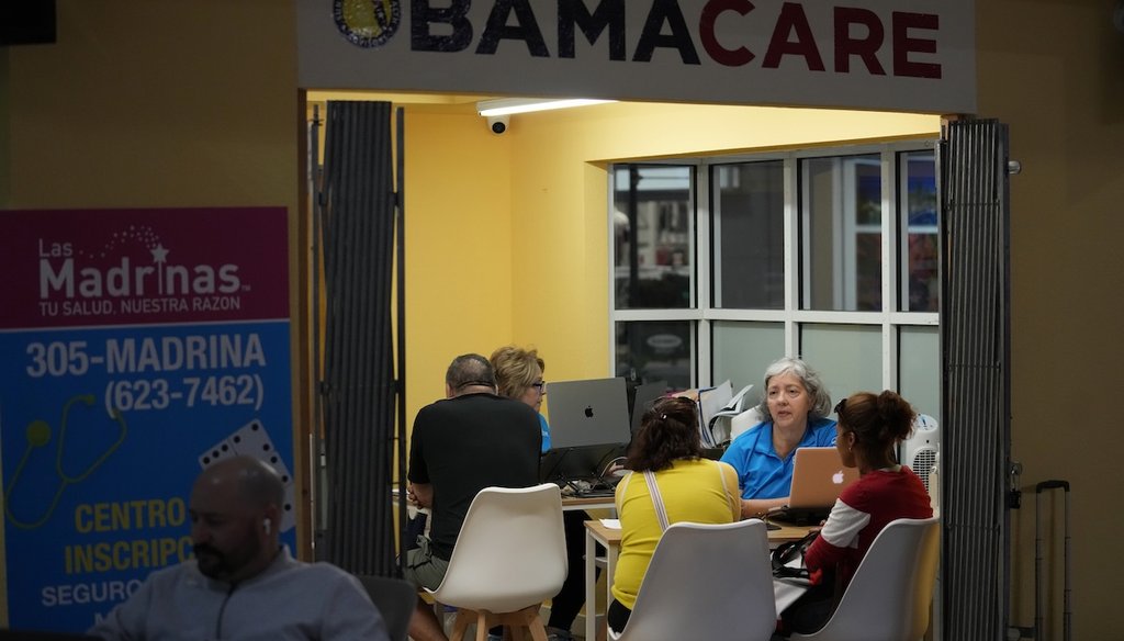 Insurance agent Maria Collado, center right, works with clients Dec. 5, 2023, at a shopping mall kiosk run by Las Madrinas de los Seguros, Spanish for "The Godmothers of Insurance," at a shopping center in Miami. (AP)