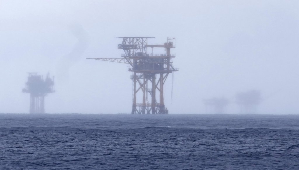 Oil platforms seen through the haze near the Flower Garden Banks National Marine Sanctuary off the coast of Galveston, Texas, on Sept. 16, 2023. (AP)