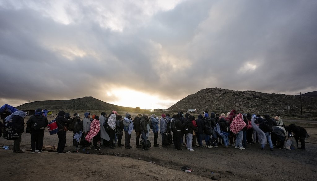 Asylum-seeking migrants line up in a makeshift, mountainous campsite to be processed after crossing the border with Mexico, Feb. 2, 2024, near Jacumba Hot Springs, Calif. (AP)