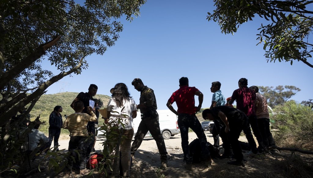 Border Patrol agents talk with migrants seeking asylum as they prepare them for transportation to go to a processing center, June 5, 2024, near Dulzura, Calif. (AP)