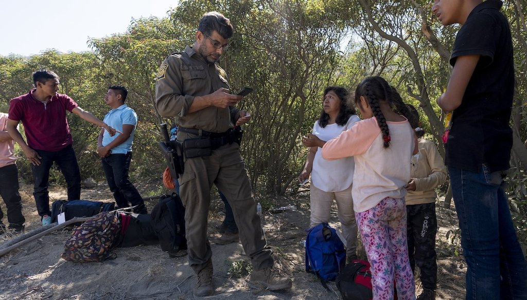 Border Patrol agents talk with migrants seeking asylum as they prepare them for transportation to go through processing, June 5, 2024, near Dulzura, Calif. (AP)