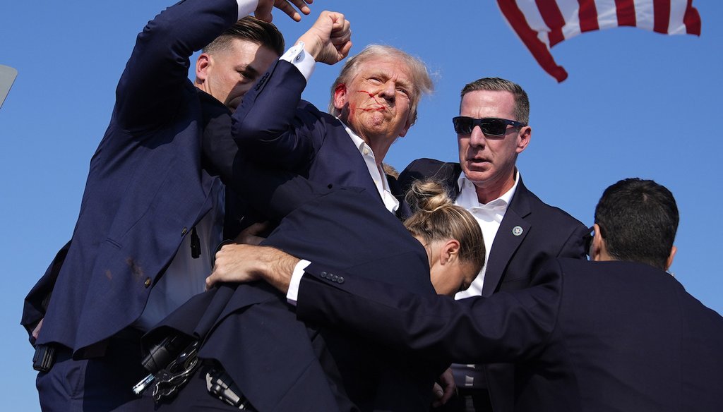 Secret Service agents surround former President Donald Trump at a campaign rally, Saturday, July 13, 2024, in Butler, Pa. (AP)