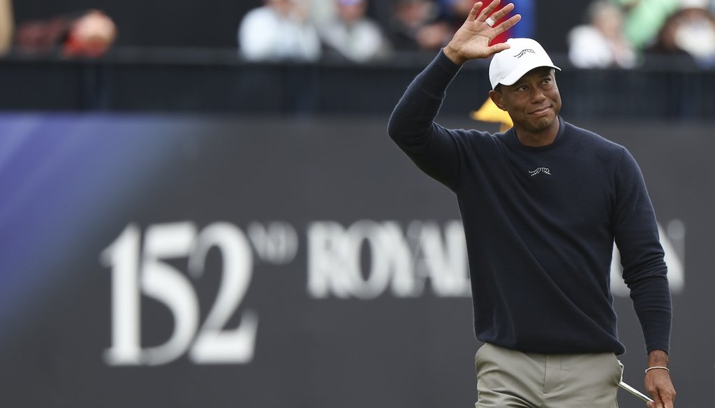 Tiger Woods of the United States waves as he walks off the 18th green following his second round of the British Open Golf Championships at Royal Troon golf club in Troon, Scotland, Friday, July 19, 2024. (AP)