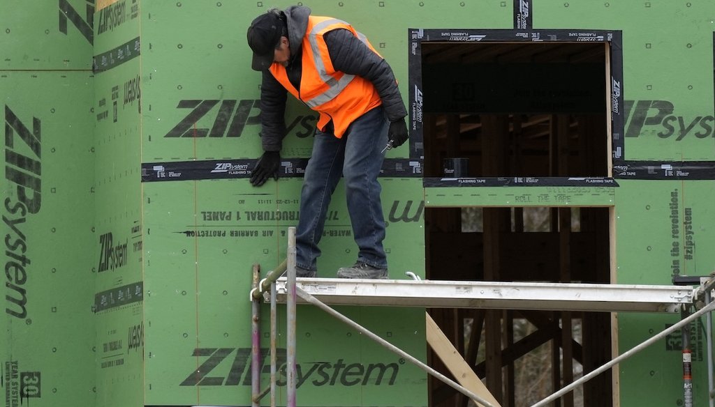 A construction worker secures sheathing at a residential building site in Mount Prospect, Ill., in 2024. (AP)