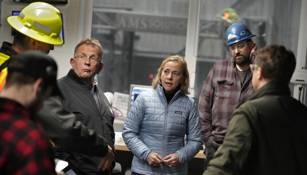 Joyce Craig, the Democratic nominee for New Hampshire governor, talks Oct. 16, 2024, with sawmill employees and local officials during a visit to the Milan Lumber mill in Milan, N.H. (AP)