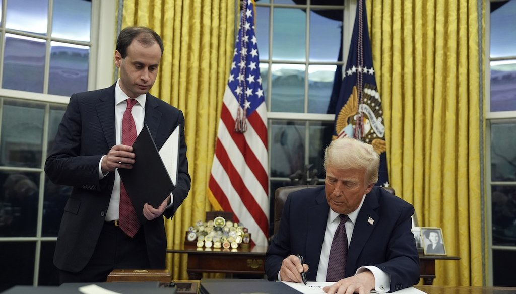 President Donald Trump signs an executive order regarding cartels in the Oval Office of the White House, Monday, Jan. 20, 2025, in Washington. (AP)