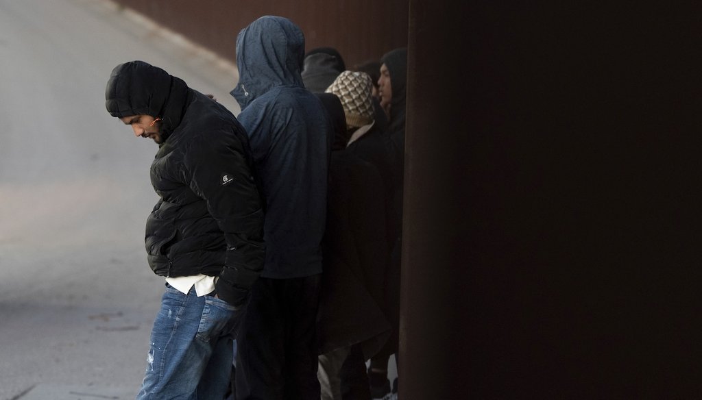 Migrants wait to apply for asylum between two border walls separating Mexico and the United States, Jan. 21, 2025, in San Diego. (AP)