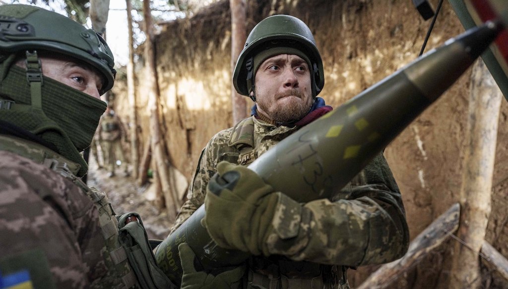 Ukrainian servicemen of 26th artillery brigade load ammunition into a howitzer before firing towards Russian positions in Ukraine's Donetsk region on Jan. 22, 2024. (AP)
