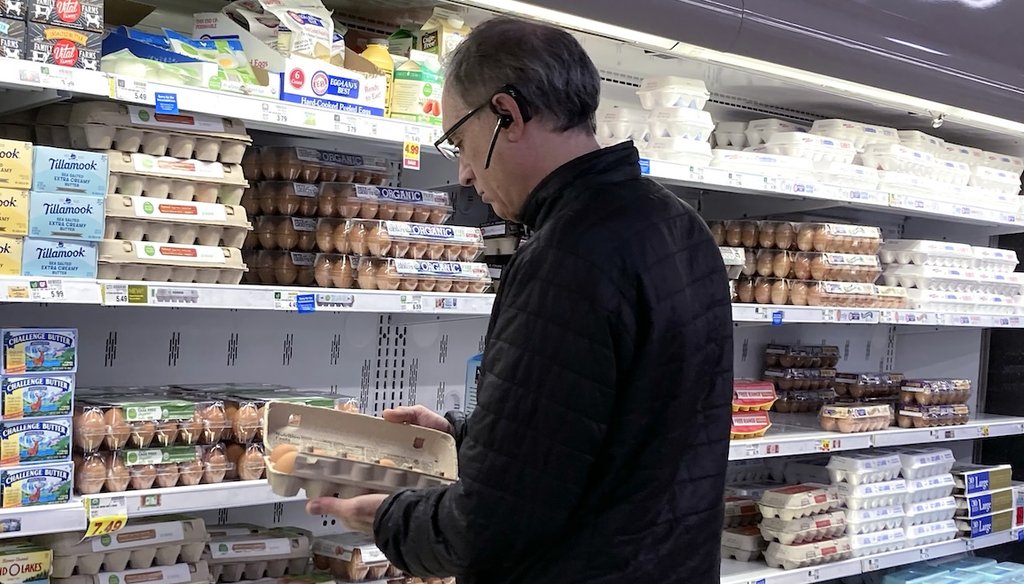 A shopper checks eggs before he purchases at a grocery store in Glenview, Ill., on Jan. 10, 2023. (AP)