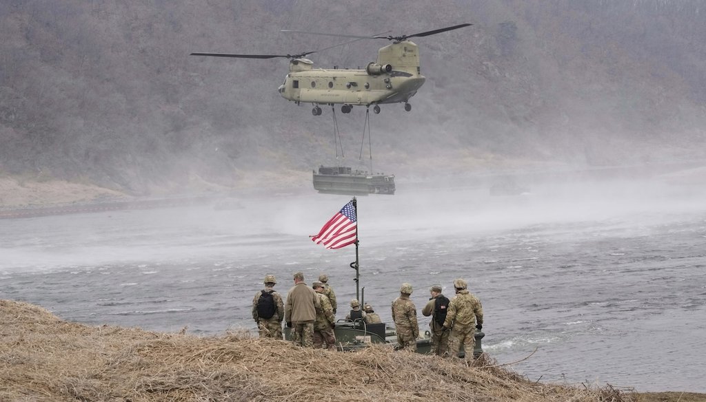 A U.S. Army CH-47 Chinook helicopter carries an equipment on the Imjin River during a joint exercise between South Korea and the United States on March 20, 2025. (AP Photo)