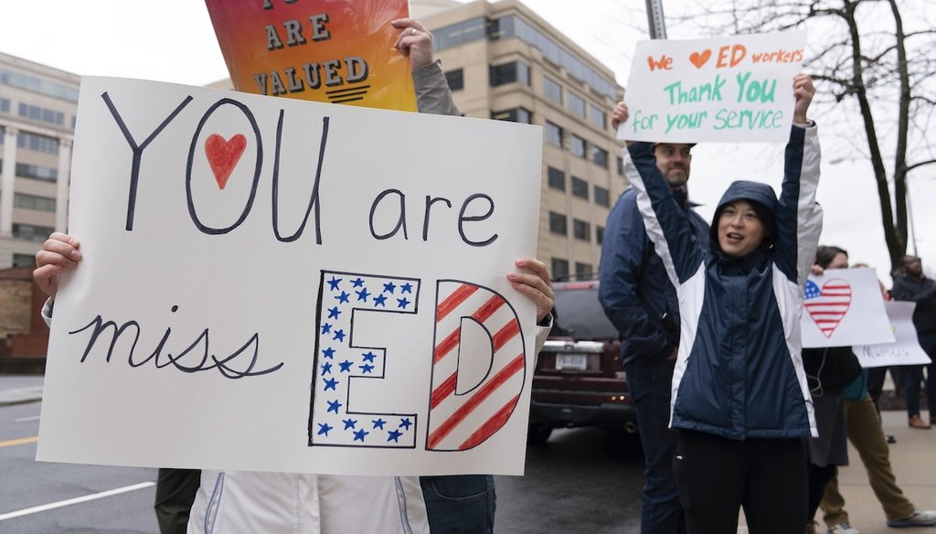 Supporters hold signs and cheer Education Department employees as they leave after retrieving their personal belongings in Washington, D.C., on March 24, 2025. (AP)