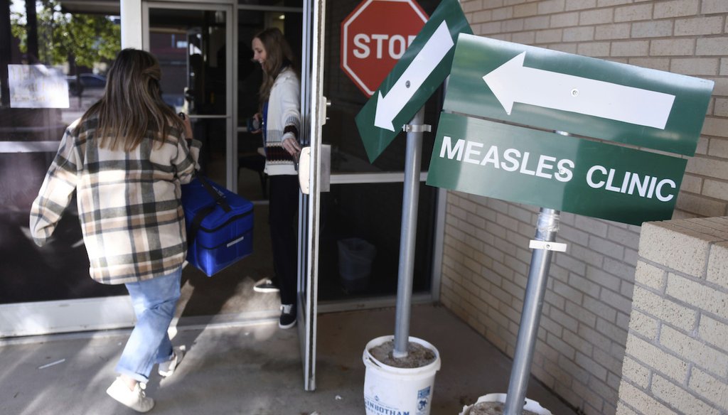 Health department staff members enter the Andrews County Health Department measles clinic carrying doses of the measles, mumps and rubella vaccine, April 8, 2025, in Andrews, Texas. (AP)