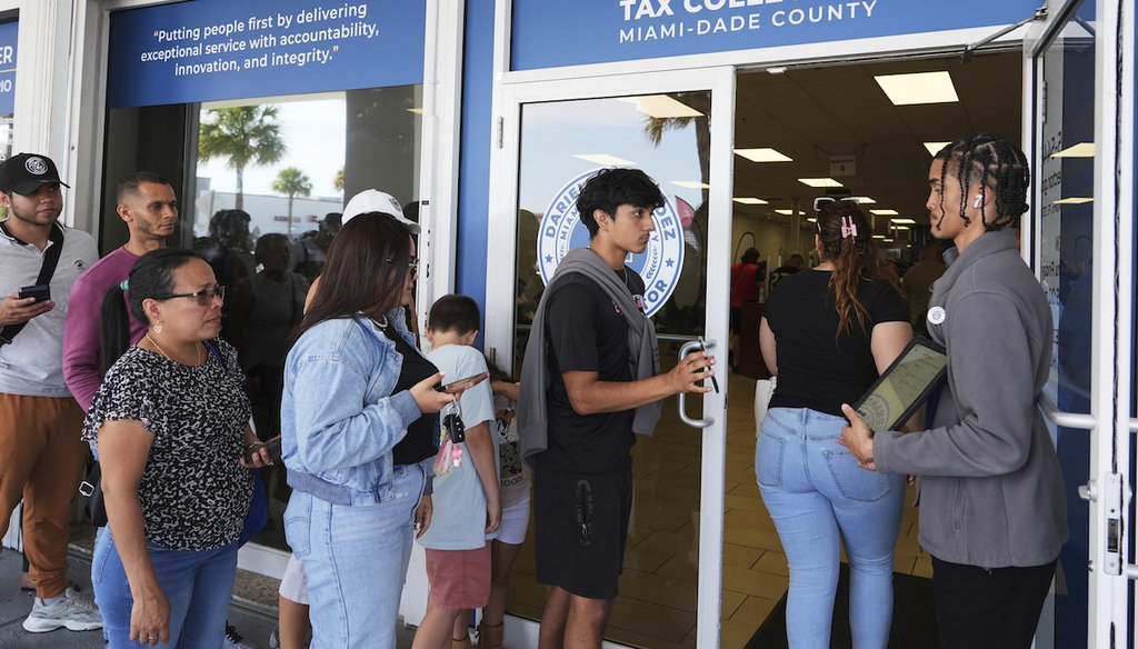 Customer Service representative Marlon Suarez, right, monitors the doorway outside of a Miami-Dade County Office of the Tax Collector, May 6, 2025, in Miami. (AP)