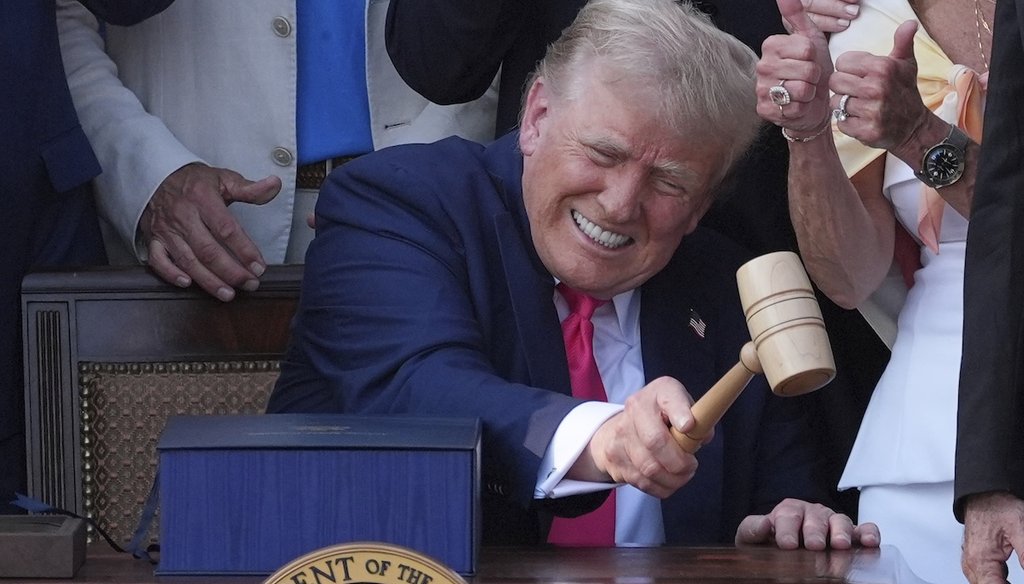 President Donald Trump bangs a gavel presented to him by House Speaker Mike Johnson after signing his signature tax and spending bill at the White House on July 4, 2025. (AP)