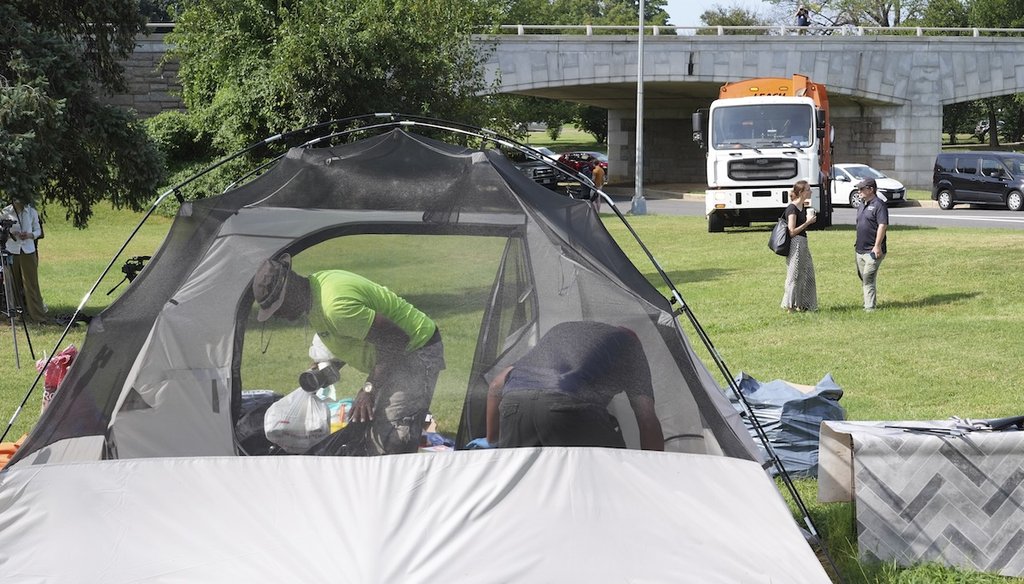 Garbage trucks wait as the homeless empty their belongs from their tents, Aug. 14, 2025, in Washington. (AP)