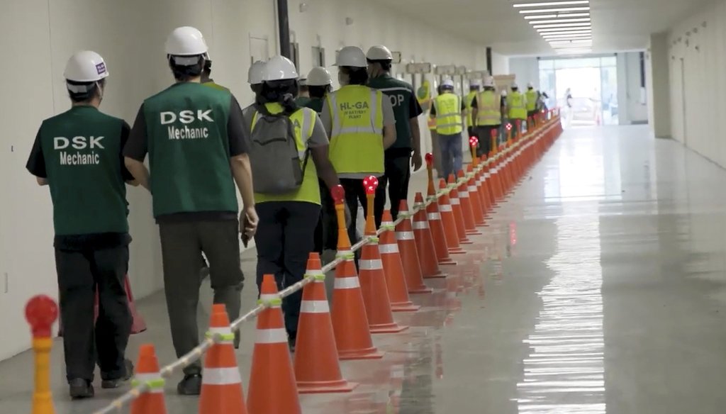 This image from video provided by U.S. Immigration and Customs Enforcement shows manufacturing plant employees being escorted outside the Hyundai Motor Group’s electric vehicle plant,  Sept. 4, 2025, in Ellabell, Ga. (USCIS via AP)
