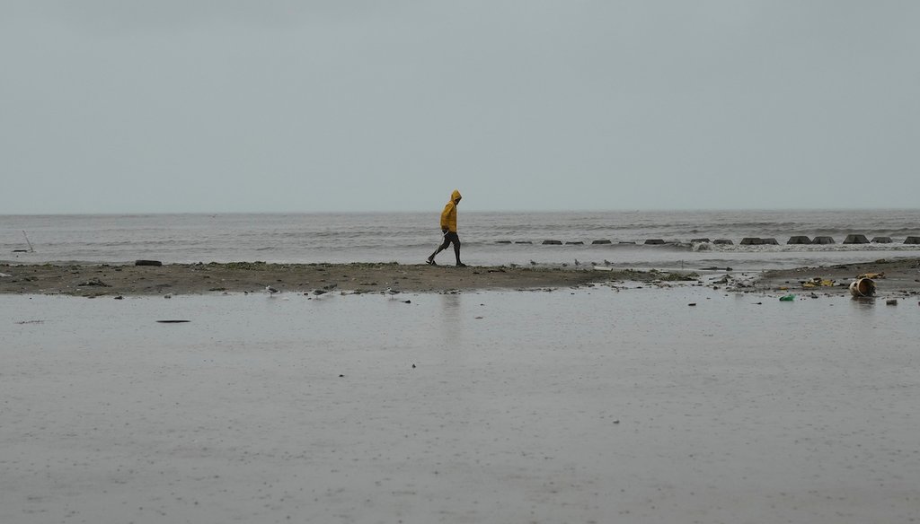A man walks along the coastline ahead of the forecasted arrival of Hurricane Melissa in Old Harbour, Jamaica, Oct. 27, 2025. (AP)