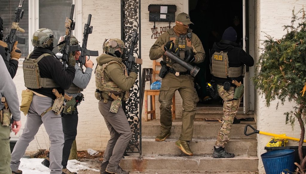 Federal immigration officers prepare to enter a home to make an arrest after an officer used a battering ram to break down a door, Jan. 11, 2026, in Minneapolis. (AP)