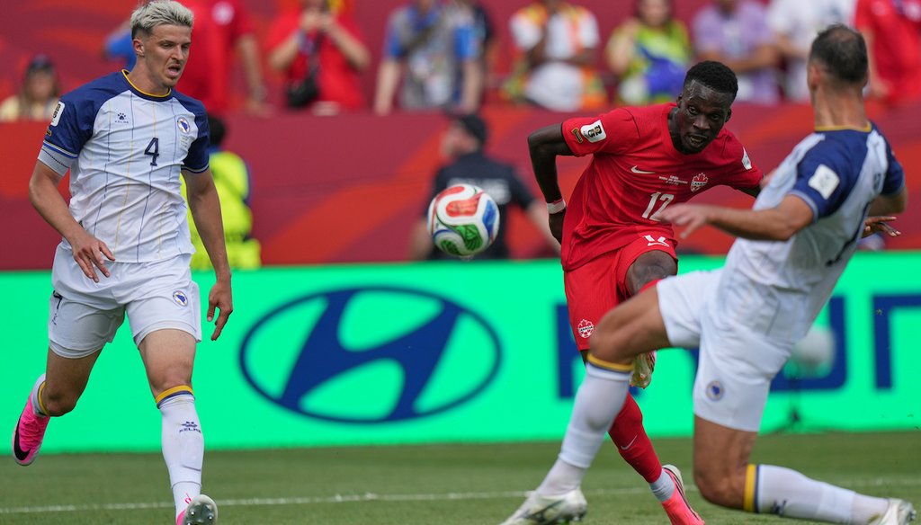 Canada's Tajon Buchanan, center, shoots at goal during the World Cup Group B soccer match between Canada and Bosnia in Toronto, June 12, 2026 (AP)