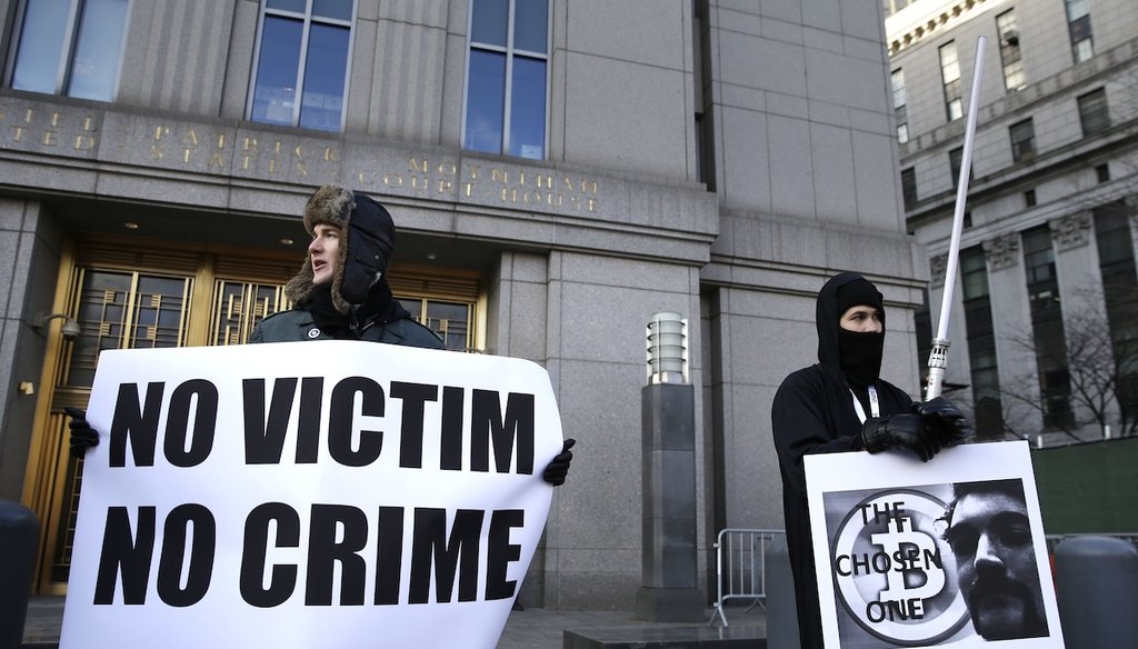 Supporters of Ross William Ulbricht hold signs Jan. 13, 2015 during the jury selection for his trial outside of federal court in New York. Ulbricht was convicted on seven counts and received a life sentence without the possibility of parole; President Don