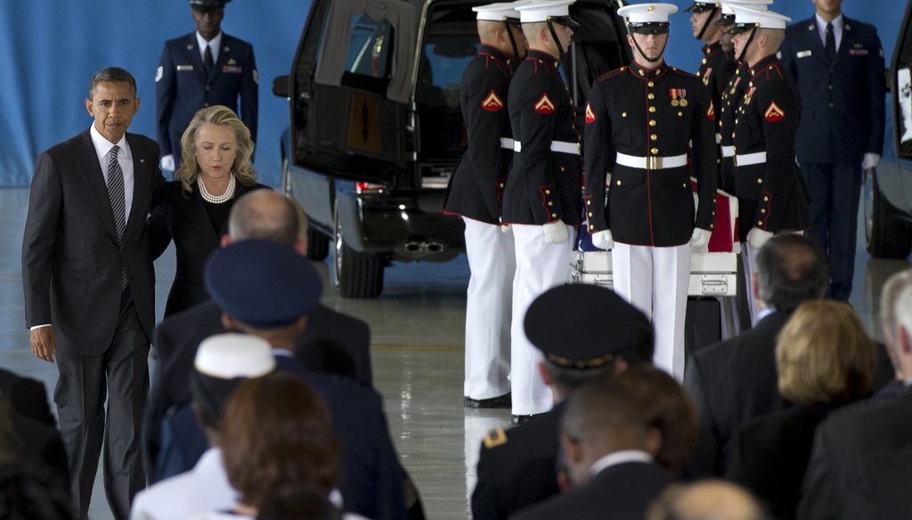 President Obama and then-Secretary of State Hillary Clinton walk back to their seats after speaking at a transfer of remains ceremony  for the Benghazi victims Sept. 14, 2012, at Joint Base Andrews. (AP Photo)
