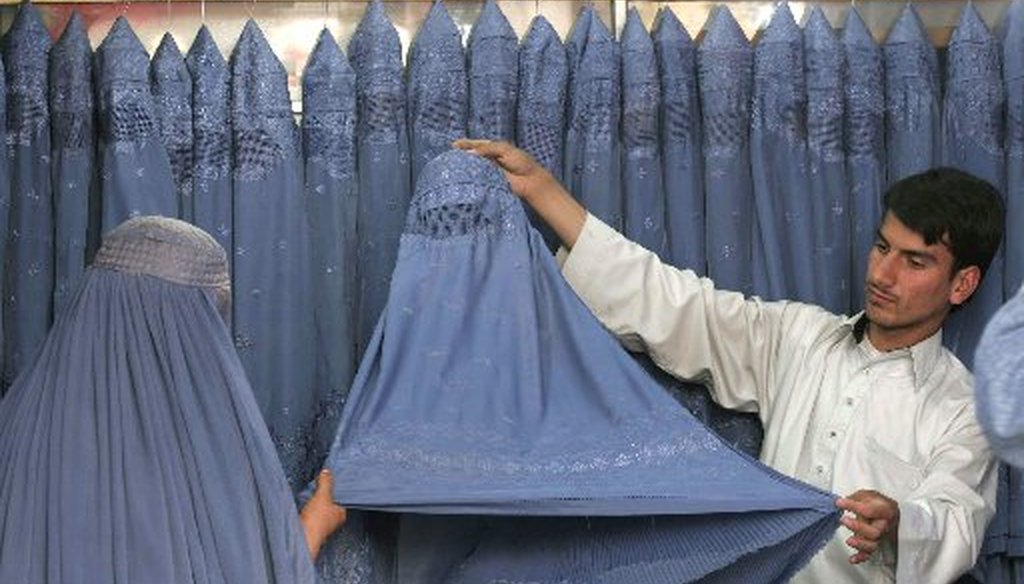 A Muslim woman looks at burqas for sale in Kabul, Afghanistan. (AP file photo/2008)