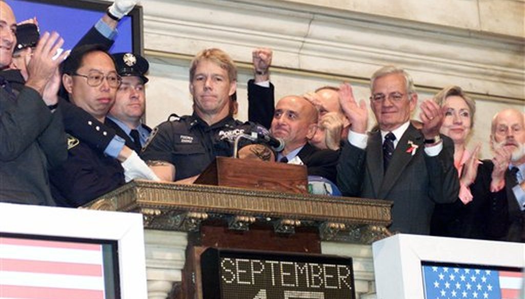 New York Stock Exchange Chairman Richard Grasso, center, is joined by politicians, members of New York's uniformed services and others on the bell podium as the the NYSE opening bell is rung, on Sept. 17, 2001 (AP/Richard Drew)