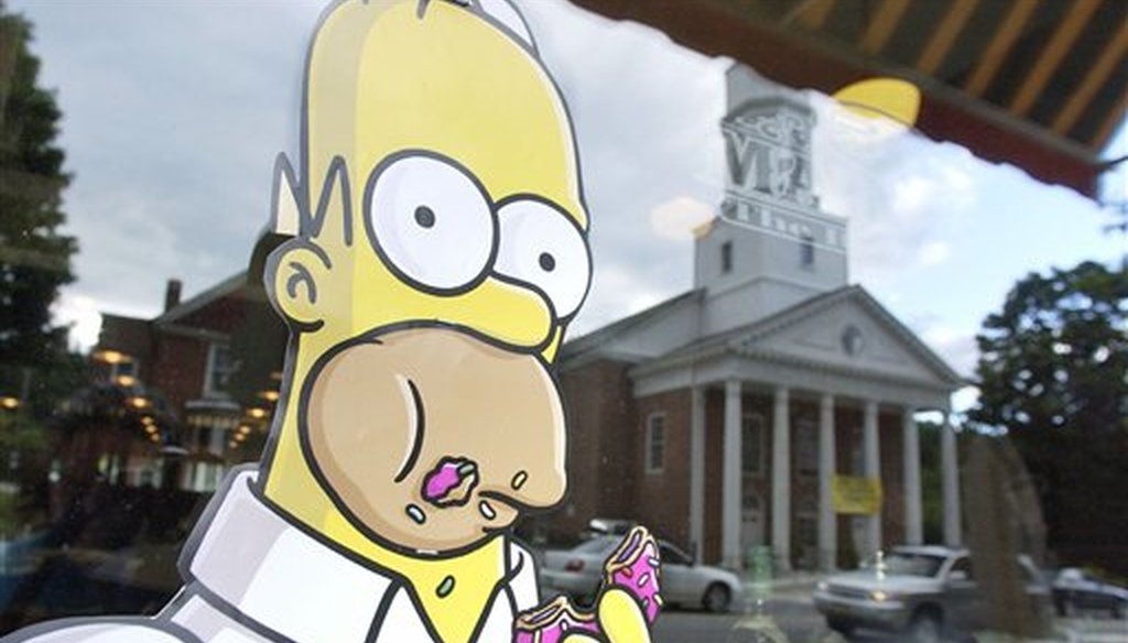 A poster of character Homer Simpson is displayed in the window of the 56 Main Street restaurant, Friday, July 20, 2007 before the premiere of "The Simpsons Movie," in Springfield, Vermont. (AP)