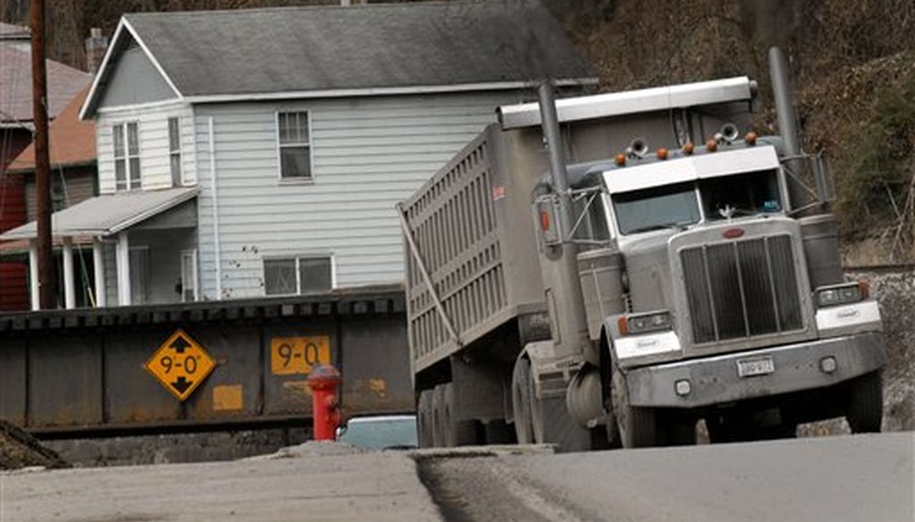 A coal truck drives through an railroad tressel near downtown Welch, W.Va. Coal brought a large population to the McDowell County in the 1940's. Now the population is shrinking and the county suffers from unemployment and poverty. (AP/Jon C. Hancock)
