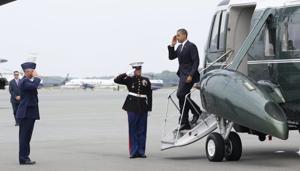 President Barack Obama salutes as he is greeted by Col. Mark Camerer, the 436th Airlift Wing Commander, left, as he steps off of Marine One, at Dover Air Force Base, Del., on Aug. 9, 2011. (AP)