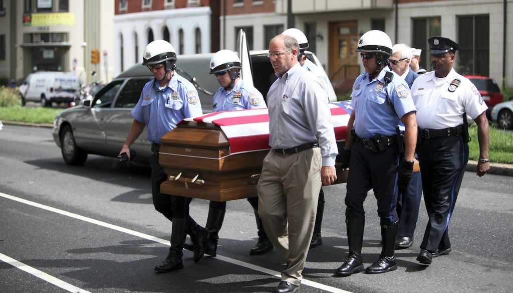 A police honor guard carries the remains of Petty Officer First Class Michael Strange, a U.S. Navy SEAL killed in the Aug. 6, 2011 helicopter crash in Afghanistan, to a Philadelphia funeral home on Aug. 15, 2011. (AP)